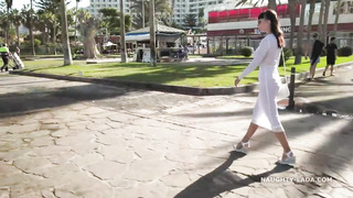 Fantastic black-haired with massive, rock-hard bosoms is dressed in a see-through sundress in a public place